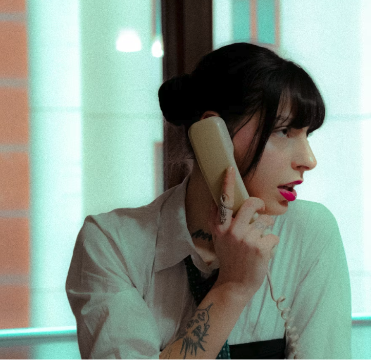 Friendly concierge on a corded phone making a calm reminder call